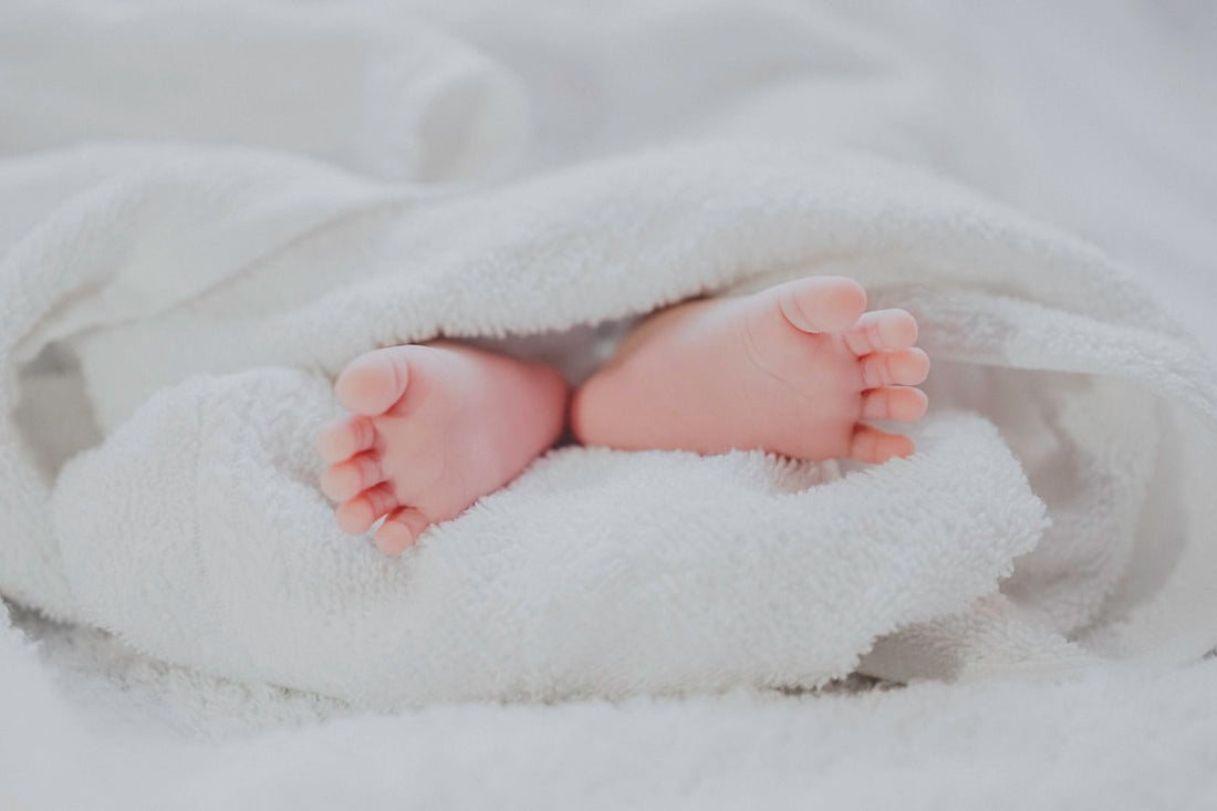 Mother breastfeeding her newborn baby comfortably at home