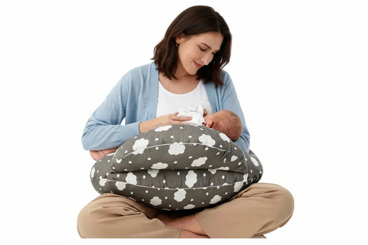 Woman breastfeeding a baby using a cloud-patterned nursing pillow on a white background
